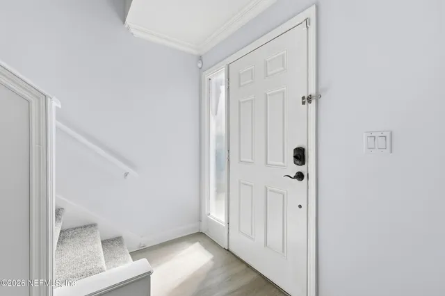 a view of a hallway with wooden floor