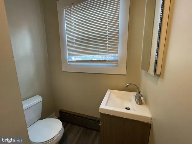 a bathroom with a sink a toilet and mirror
