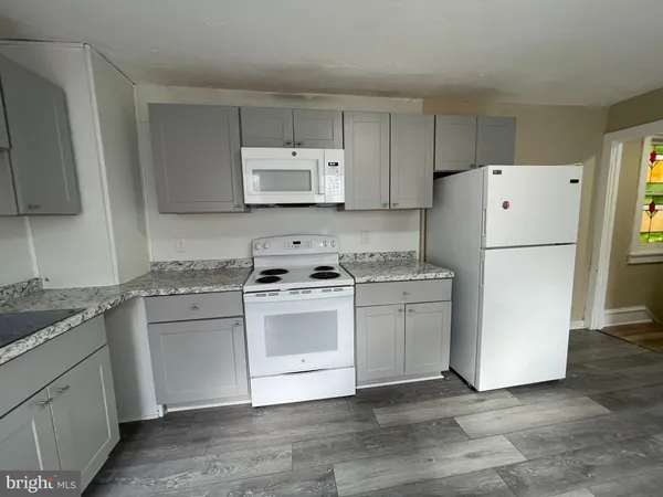 a kitchen with a white cabinets and white appliances