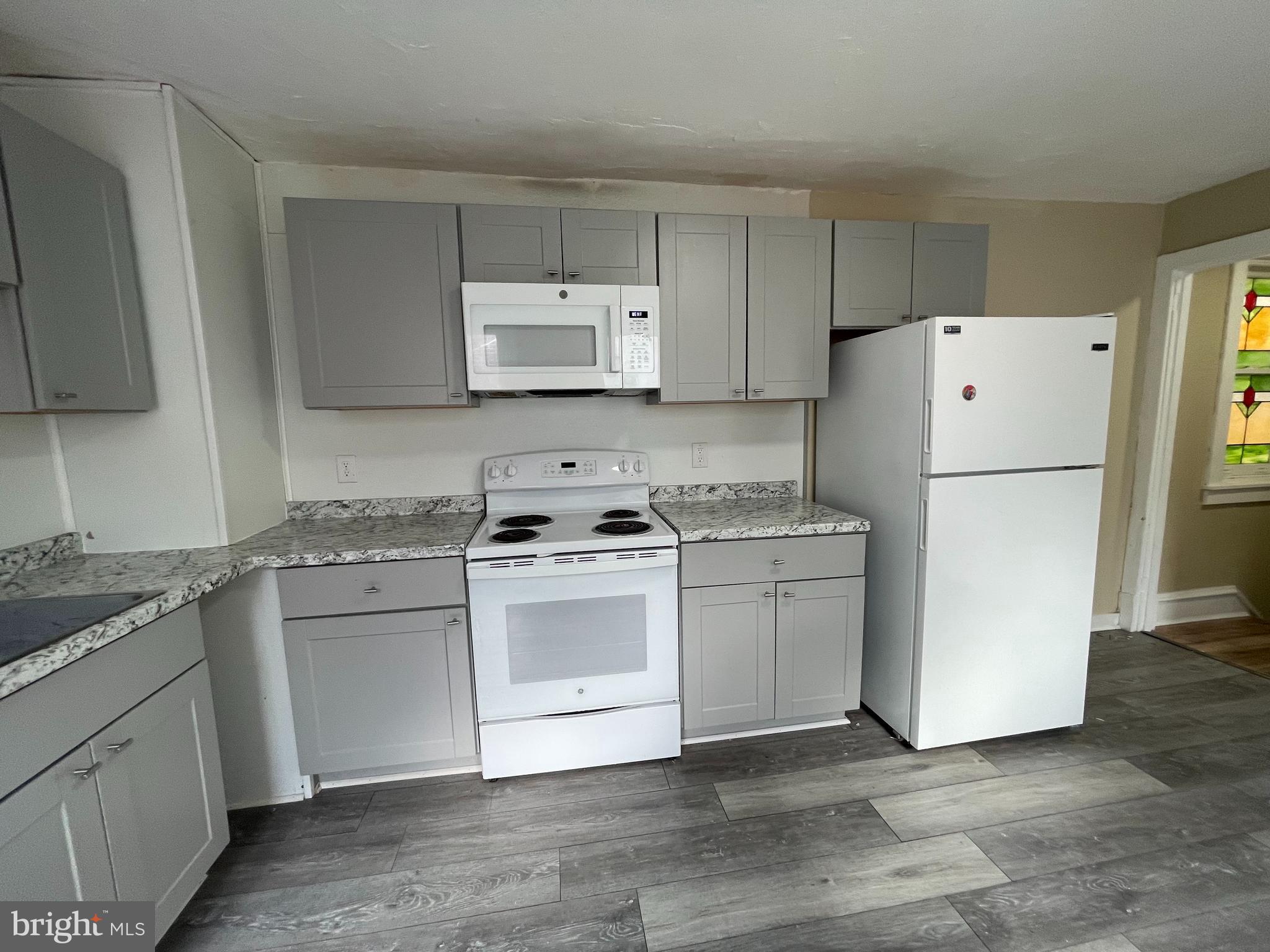 34 North 11th Street Reading, PA 19601 - Photo 4 of 15 a kitchen with a white cabinets and white appliances