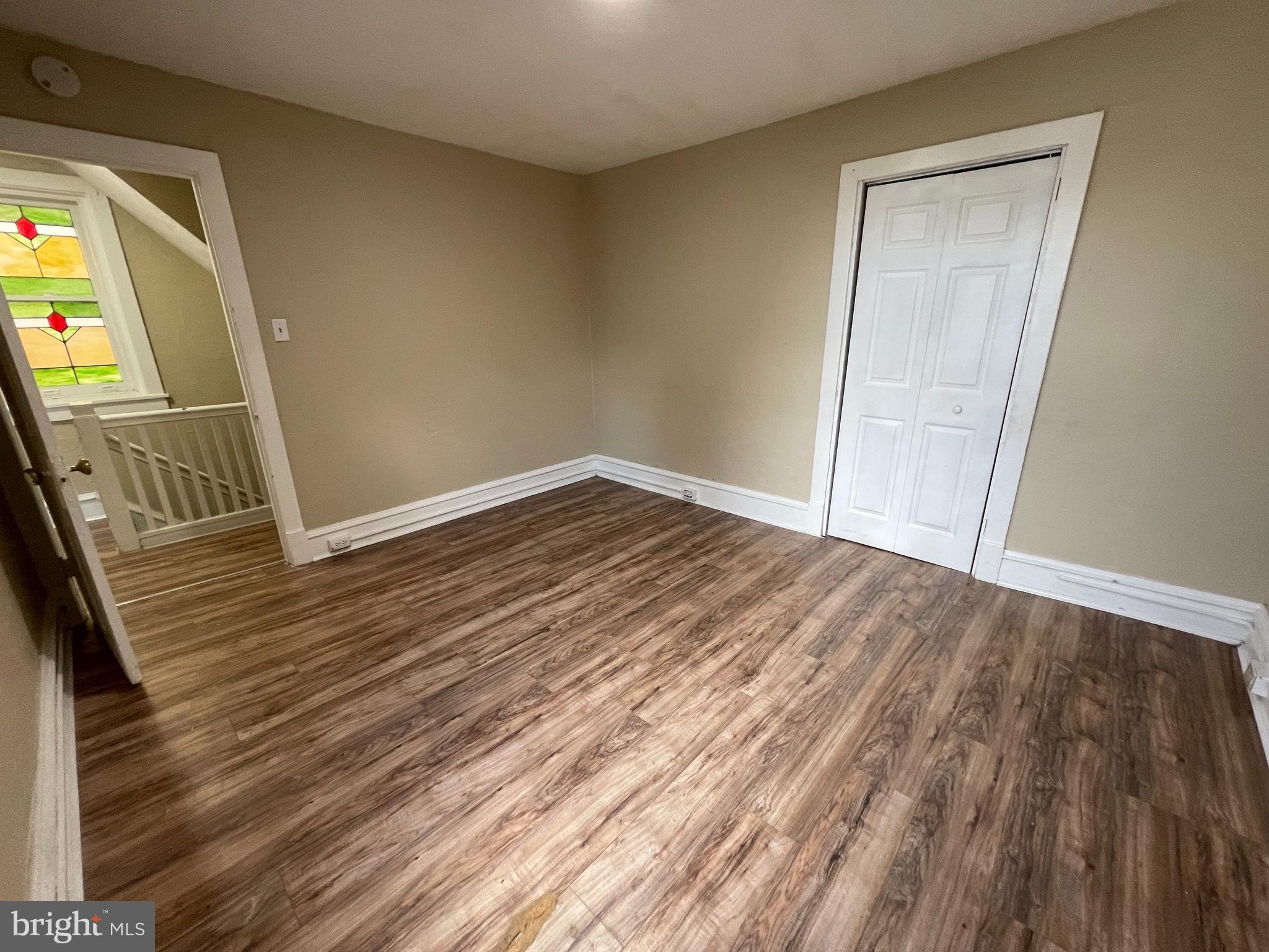 34 North 11th Street Reading, PA 19601 - Photo 7 of 15 a view of an empty room with wooden floor and a window