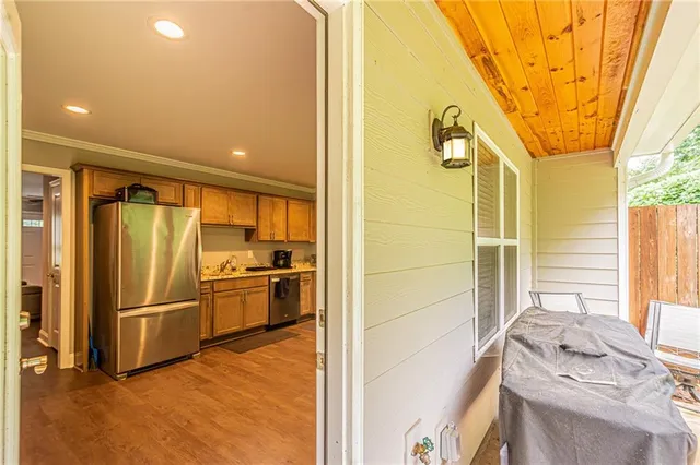 a kitchen with stainless steel appliances a refrigerator and a stove top oven