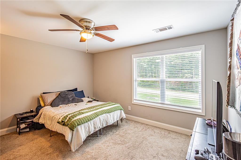 502 Wimpy Mill Road Dahlonega, GA 30533 - Photo 17 of 30 a bedroom with a bed and next to a window