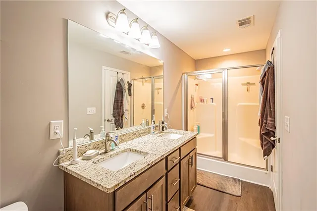 a bathroom with a granite countertop sink mirror and a