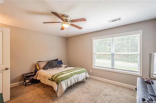 a bedroom with a bed and window