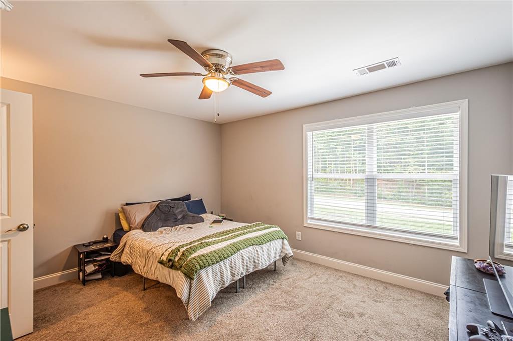 502 Wimpy Mill Road Dahlonega, GA 30533 - Photo 22 of 30 a bedroom with a bed and window