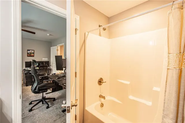 a view of a bathroom with a tub and shower