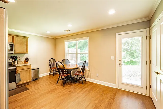 a view of a dining room with furniture and a window