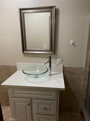 an empty room with wooden floor and entrance