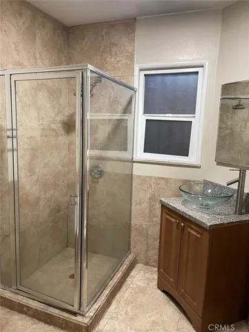 an empty room with a wooden floor and a window