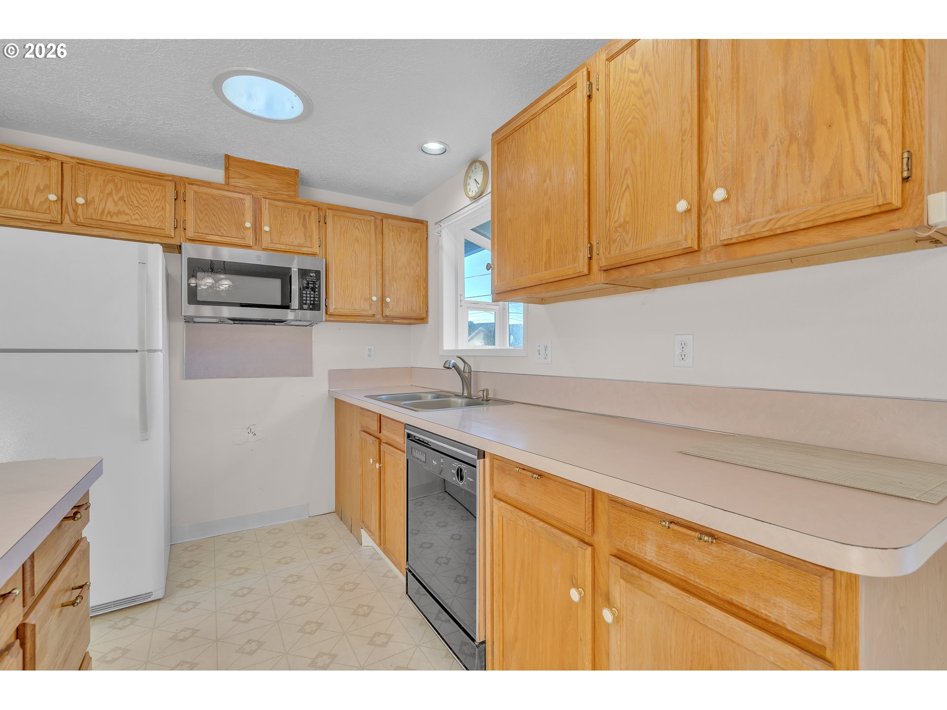 1379 Sallal Road Woodburn, OR 97071 - Photo 7 of 24 a kitchen with stainless steel appliances granite countertop a refrigerator sink and cabinets