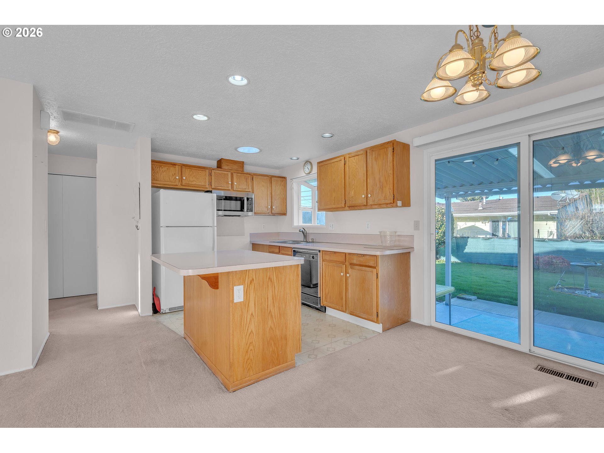1379 Sallal Road Woodburn, OR 97071 - Photo 8 of 24 a living room with stainless steel appliances kitchen island granite countertop a refrigerator a stove top oven a sink and dishwasher