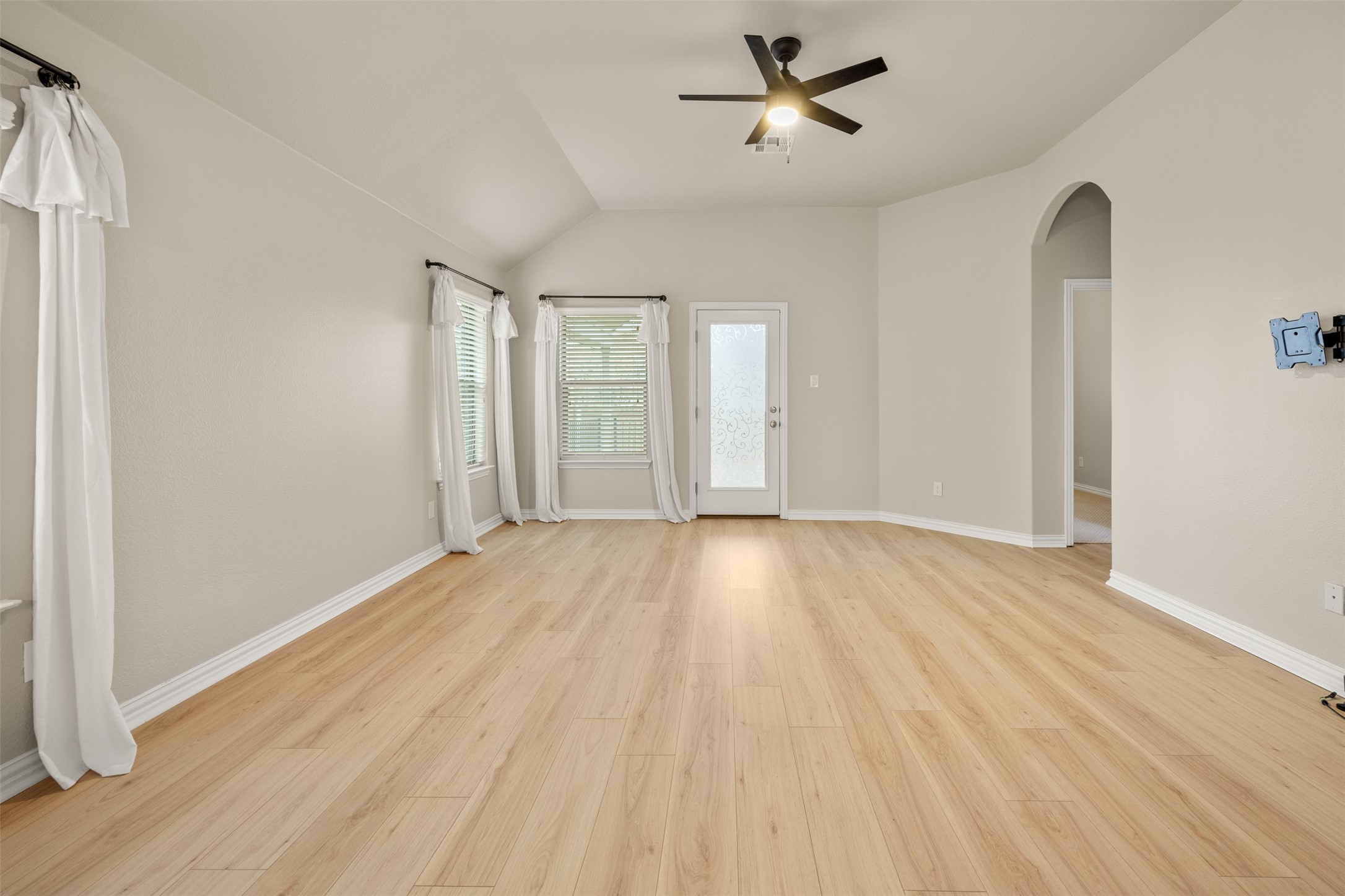 249 Saffron Springs Buda, TX 78610 - Photo 11 of 21 a view of empty room with wooden floor and fan