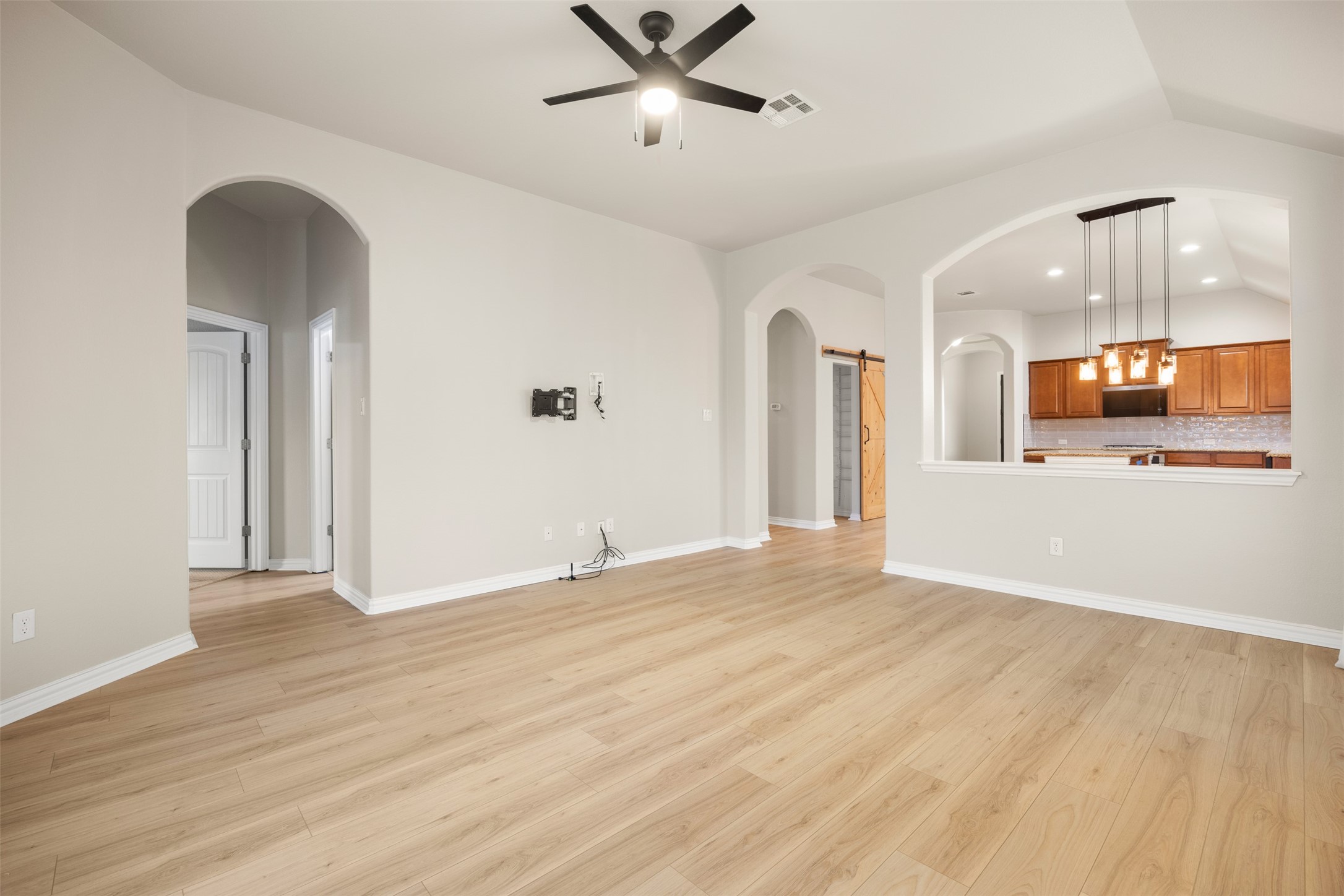 249 Saffron Springs Buda, TX 78610 - Photo 13 of 21 wooden floor in an empty room with a window