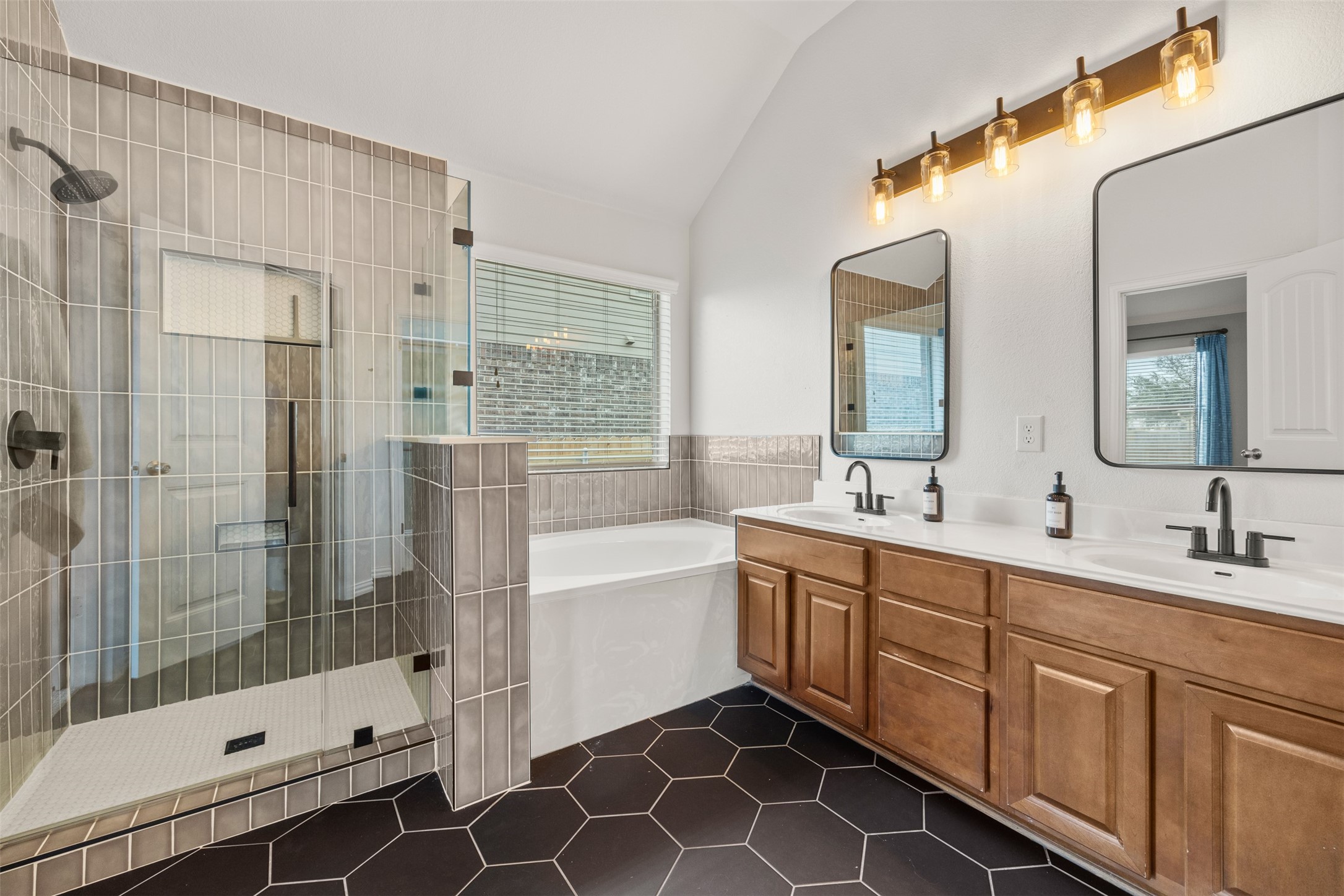 249 Saffron Springs Buda, TX 78610 - Photo 16 of 21 a bathroom with a double vanity sink mirror and shower
