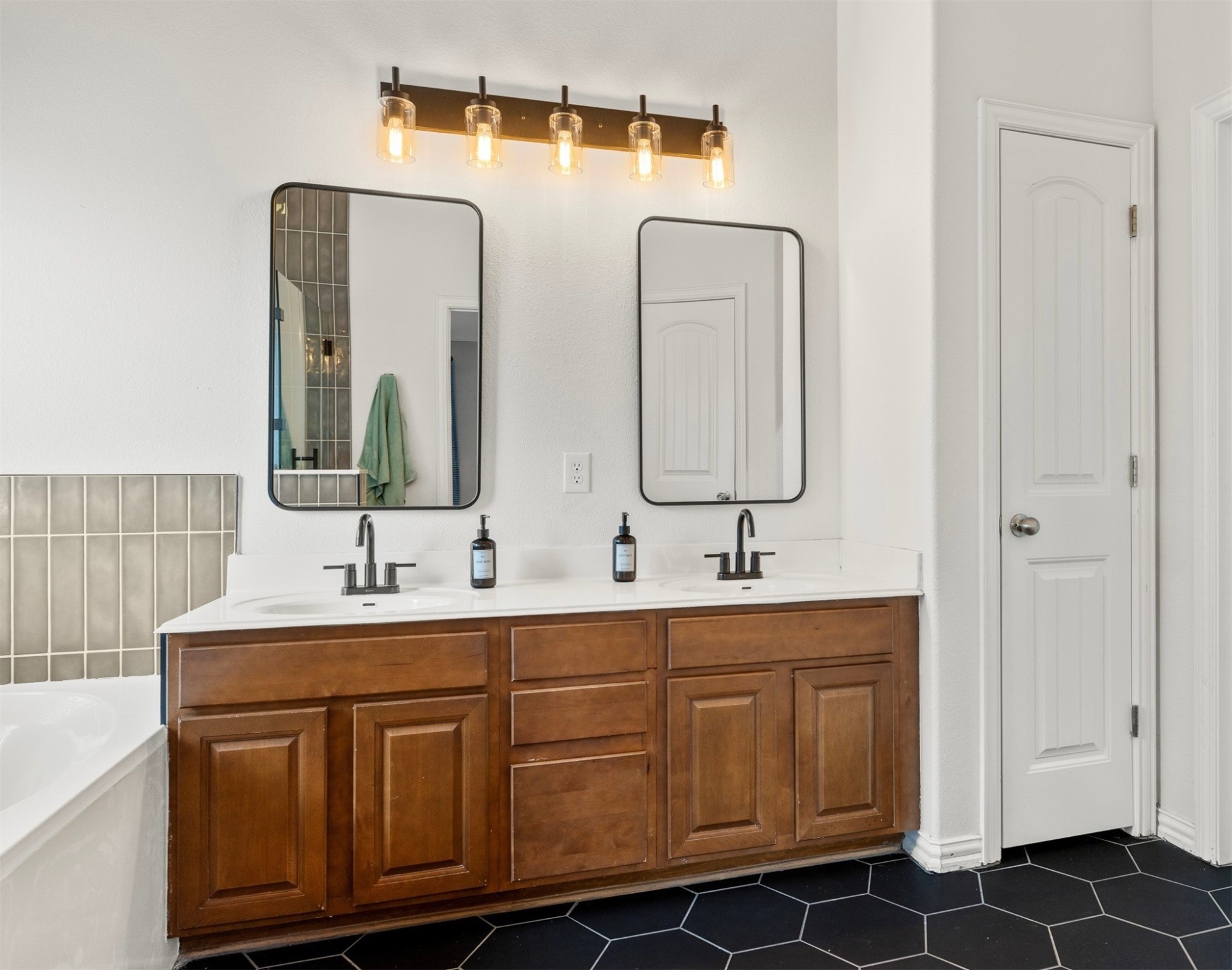 249 Saffron Springs Buda, TX 78610 - Photo 17 of 21 a bathroom with a double vanity sink and mirror