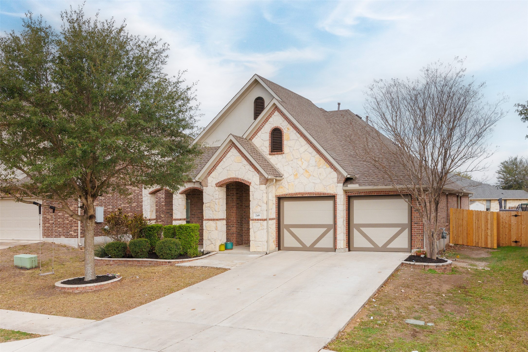 249 Saffron Springs Buda, TX 78610 - Photo 2 of 21 a front view of a house with a yard and garage