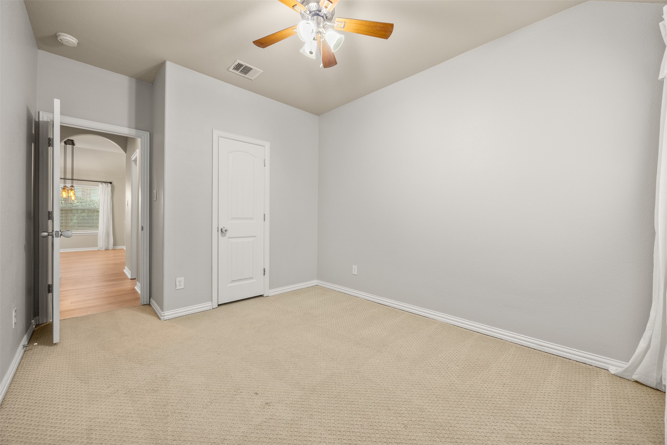 249 Saffron Springs Buda, TX 78610 - Photo 21 of 21 an empty room with chandelier fan and windows