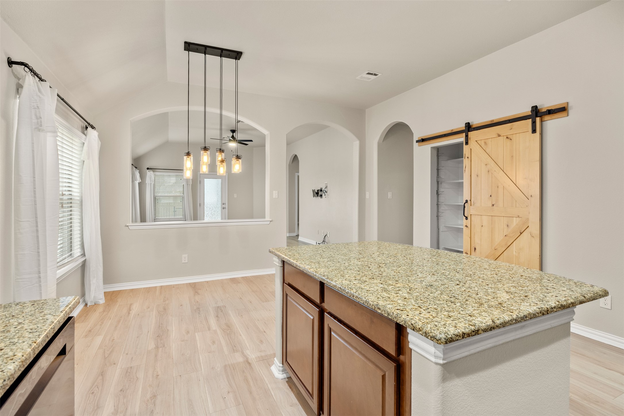 249 Saffron Springs Buda, TX 78610 - Photo 10 of 21 a bathroom with a granite countertop sink a mirror and a wooden floor
