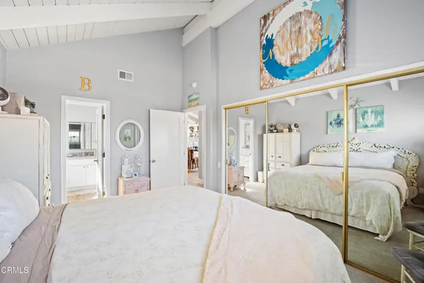 a bedroom with a bed and a painting on the wall