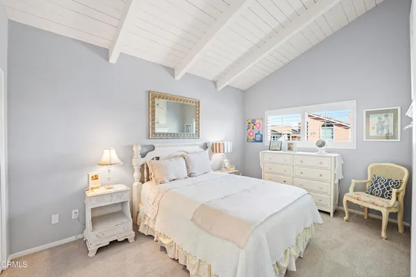 a bedroom with a bed and a chair