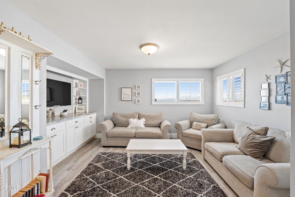 2405 Ocean Drive Oxnard, CA 93035 - Photo 27 of 40 a living room with furniture and a flat screen tv