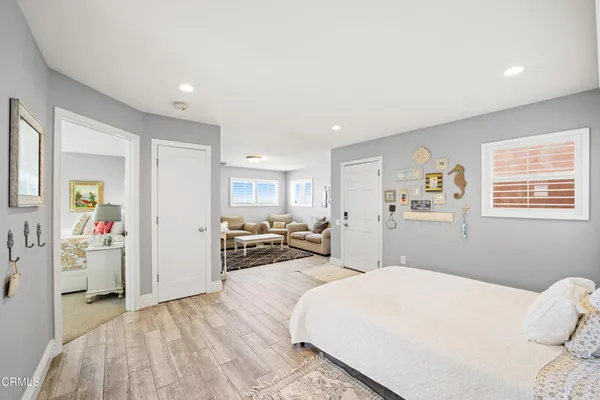 a bedroom with a bed cabinets and window