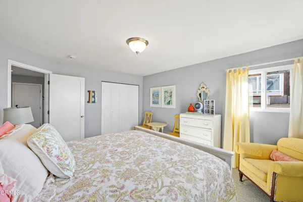 a bedroom with a large bed and a couch