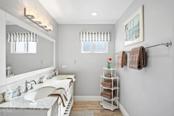 a bathroom with a sink mirror vanity and a window