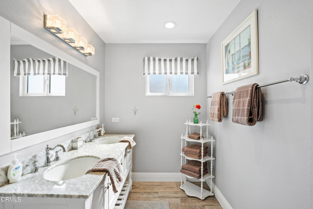 2405 Ocean Drive Oxnard, CA 93035 - Photo 33 of 40 a bathroom with a sink mirror vanity and a window