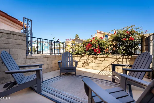 a view of a chairs and table in the balcony