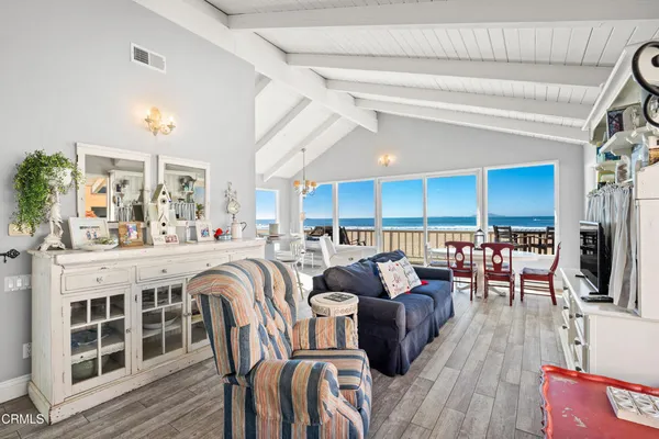 a living room with lots of furniture and kitchen view