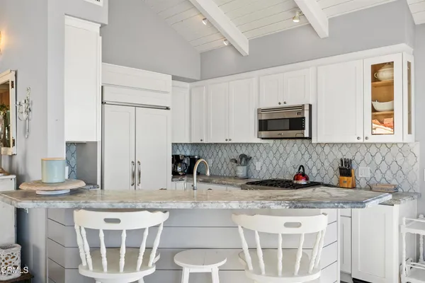 a kitchen with stainless steel appliances granite countertop a sink and a stove