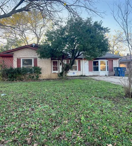 a house that has a tree in front of it