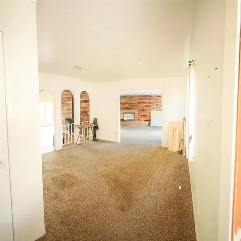 a view of a livingroom with wooden floor and furniture