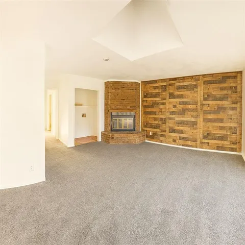 a view of an empty room with a fireplace