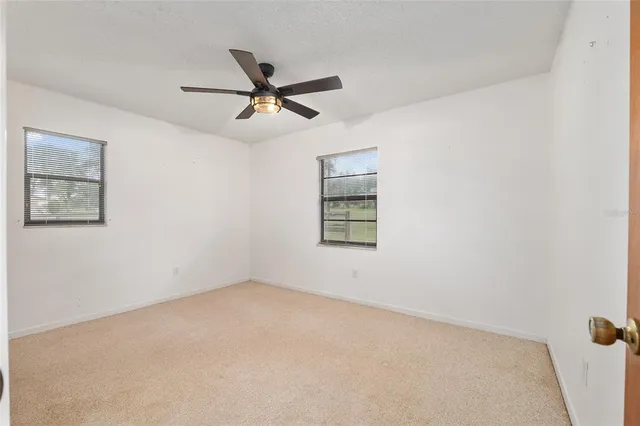 a view of a porch with wooden floor and furniture