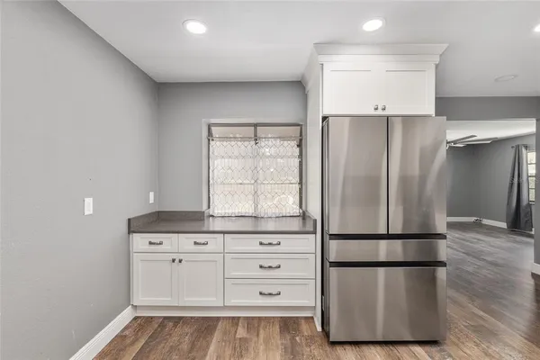 a kitchen with stainless steel appliances a refrigerator and a window
