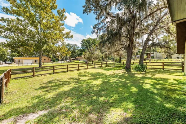 a view of a house with a yard and sitting area