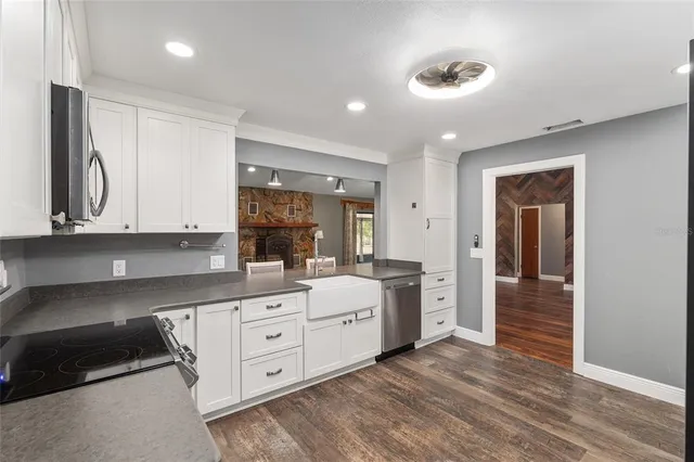 a large kitchen with cabinets and wooden floor