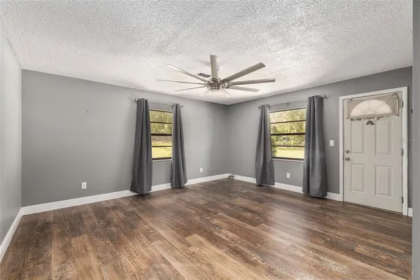 a view of a big room with windows and cabinet