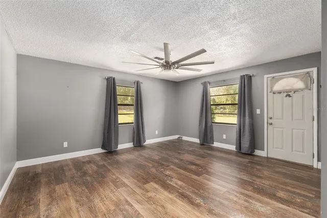 a view of a big room with windows and cabinet