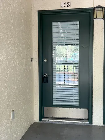 a view of wooden door and a window