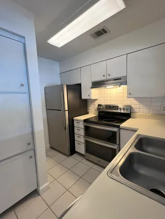 a kitchen with a refrigerator and a stove