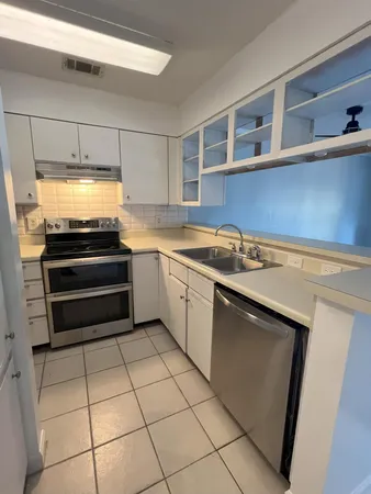 a kitchen with a cabinets and appliances