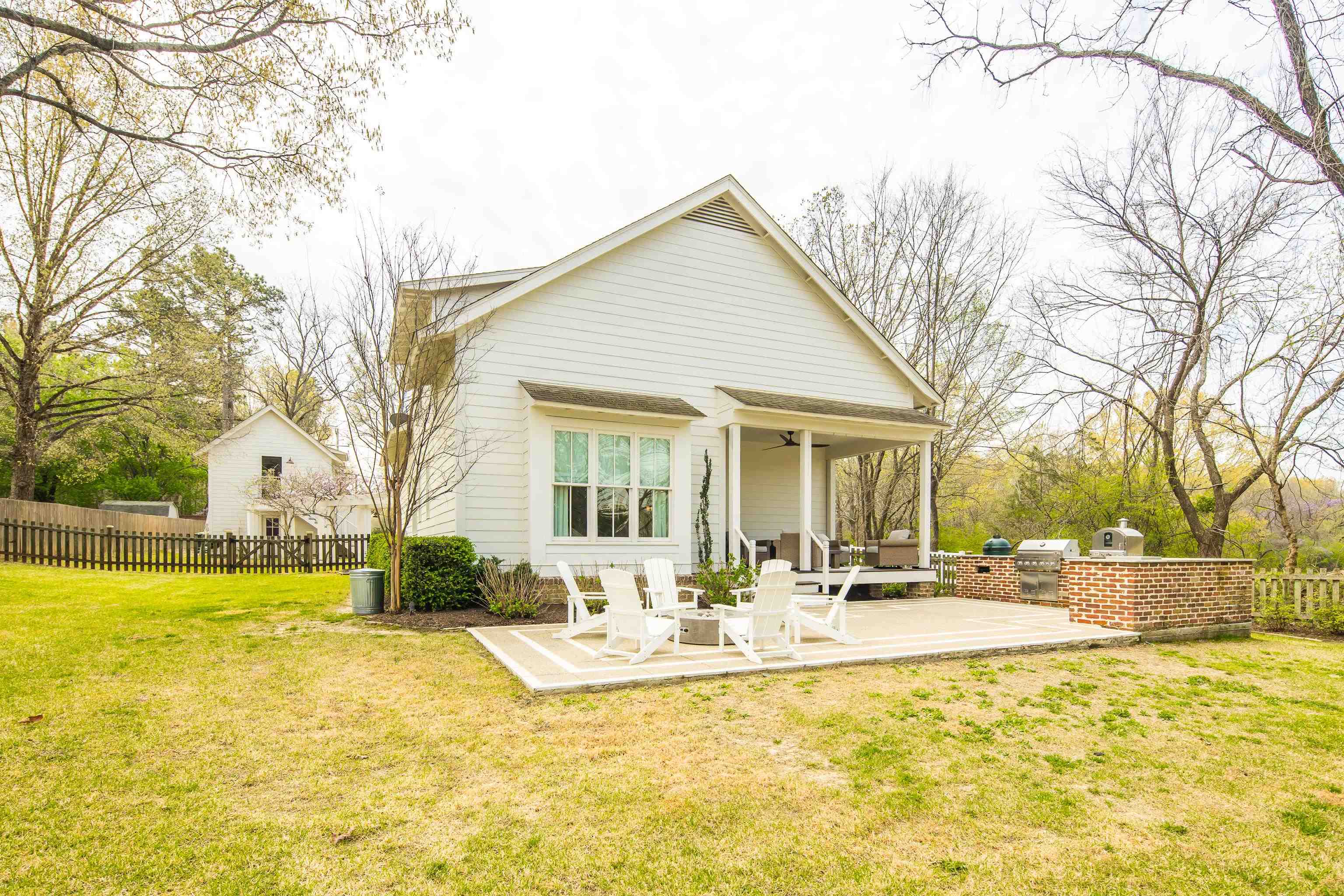 1480 Frank Road Collierville, TN 38017 - Photo 36 of 39 a view of a white house with a large pool and a lawn chairs under a large tree