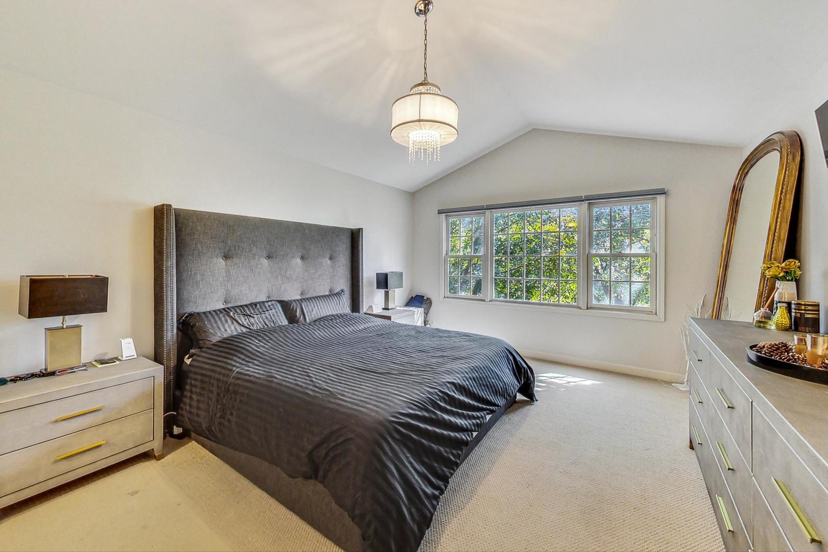 74 Trent Court Burr Ridge, IL 60527 - Photo 13 of 30 a bedroom with a bed and a flat tv screen on dresser