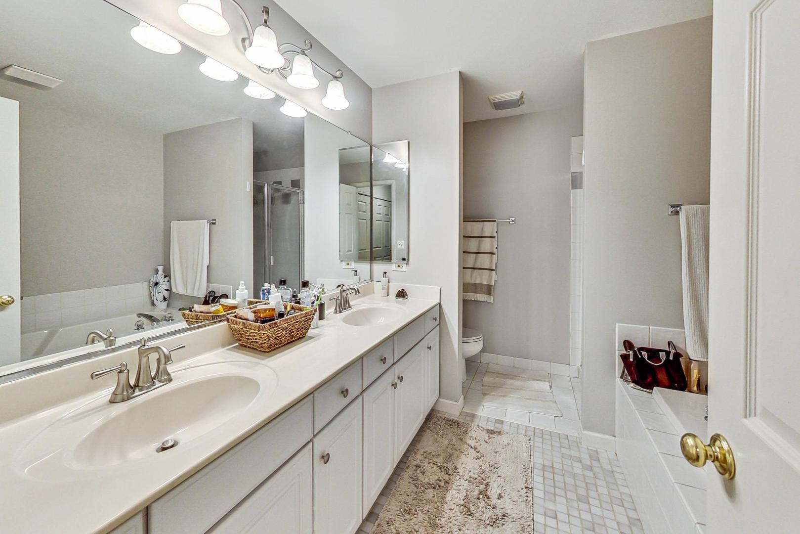 74 Trent Court Burr Ridge, IL 60527 - Photo 15 of 30 a bathroom with a double vanity sink mirror and shower