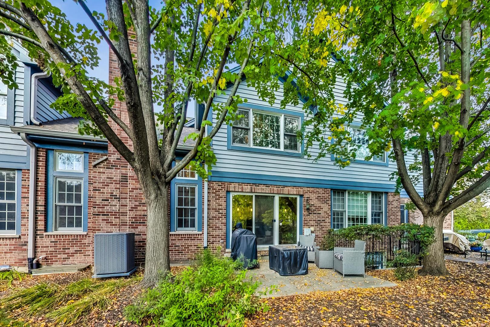 74 Trent Court Burr Ridge, IL 60527 - Photo 22 of 30 a front view of a house with garden and trees