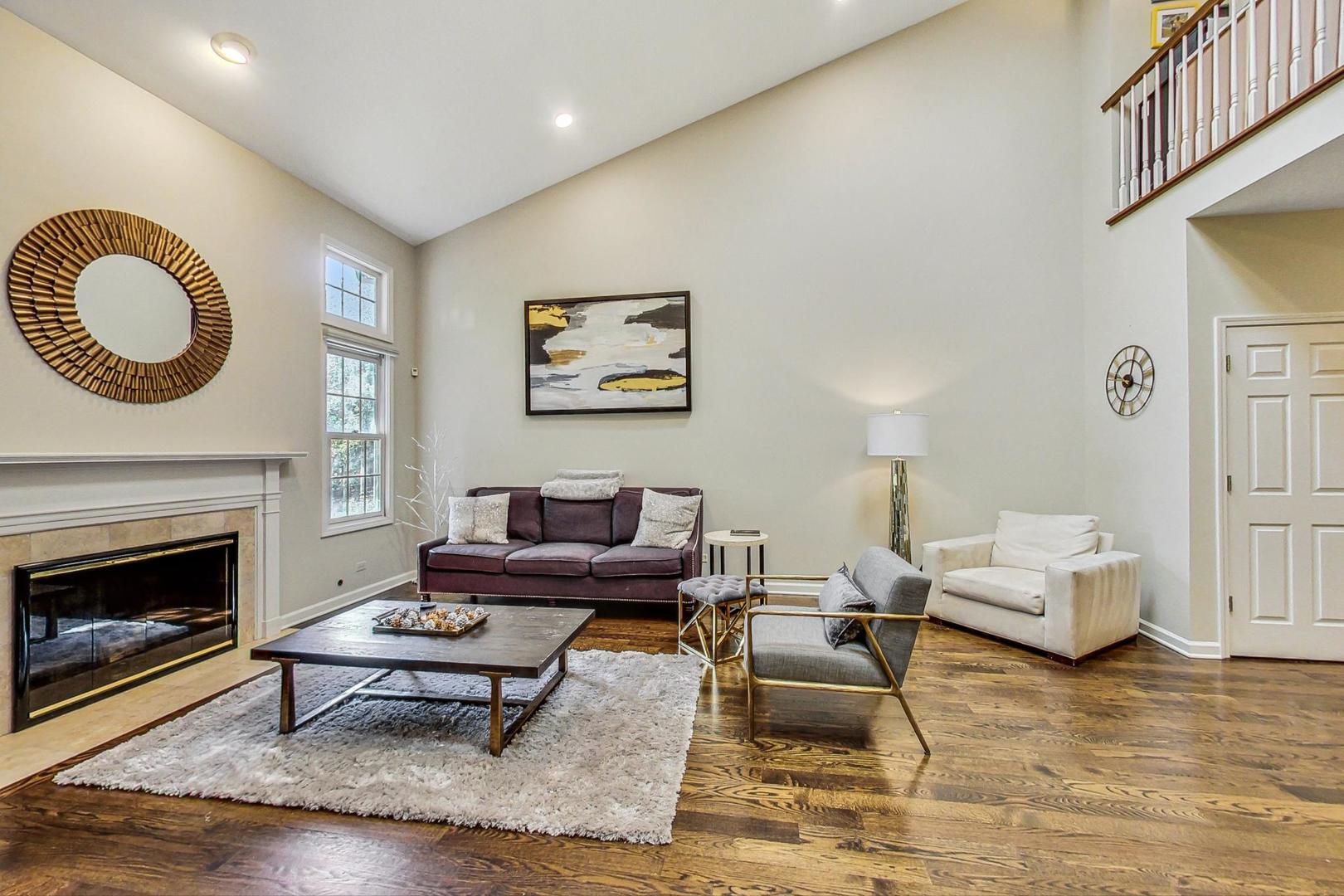 74 Trent Court Burr Ridge, IL 60527 - Photo 5 of 30 a living room with furniture a fireplace and a window